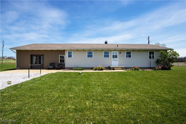 back of house with a lawn and a patio area