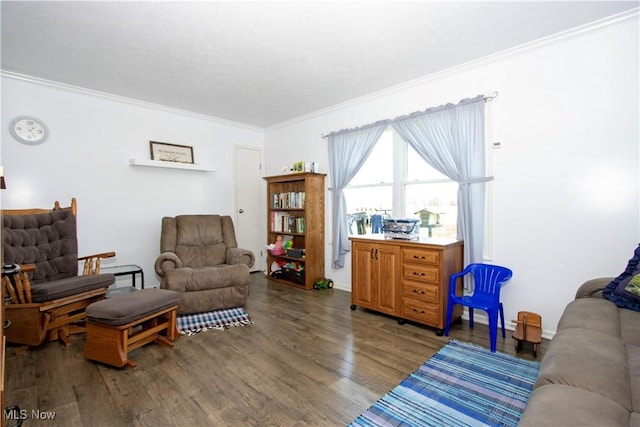 sitting room featuring wood finished floors and crown molding