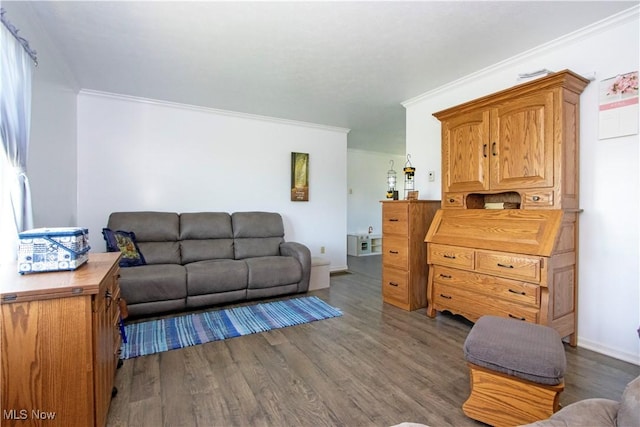 living room with baseboards, wood finished floors, and crown molding