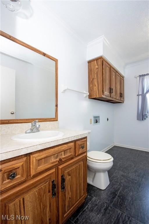 bathroom featuring ornamental molding, toilet, and vanity