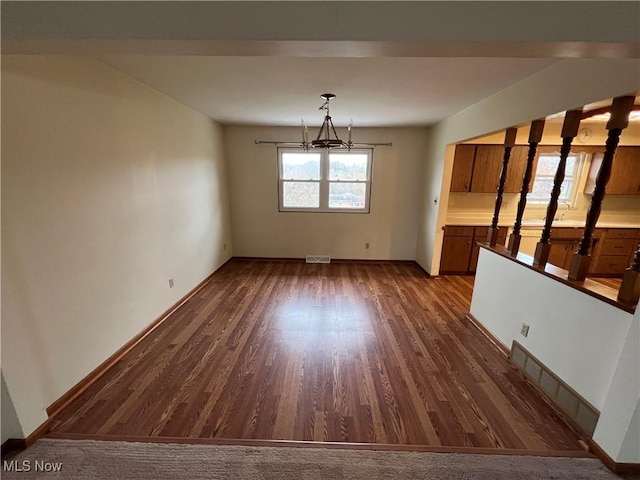 260 Scenery Dr, Weirton, WV 26062 - unfurnished dining area featuring a chandelier, baseboards, dark wood finished floors, and visible vents