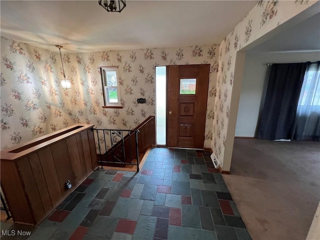 260 Scenery Dr, Weirton, WV 26062 - foyer with a wealth of natural light, baseboards, stone tile floors, and wallpapered walls
