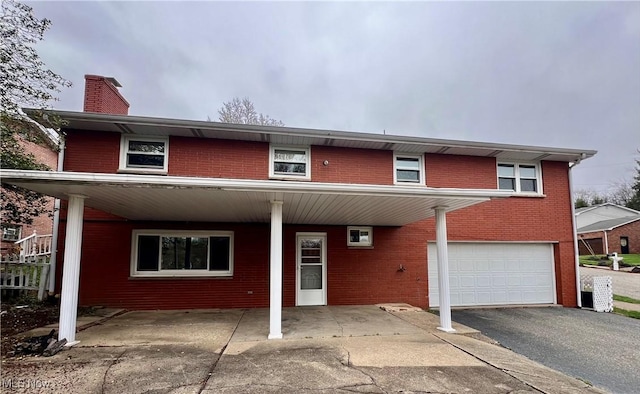 260 Scenery Dr, Weirton, WV 26062 - view of front facade featuring brick siding, an attached garage, driveway, and a chimney