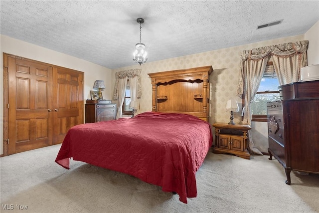 5706 Kemary Ave SW, Navarre, OH 44662 - carpeted bedroom with a textured ceiling, an inviting chandelier, and visible vents