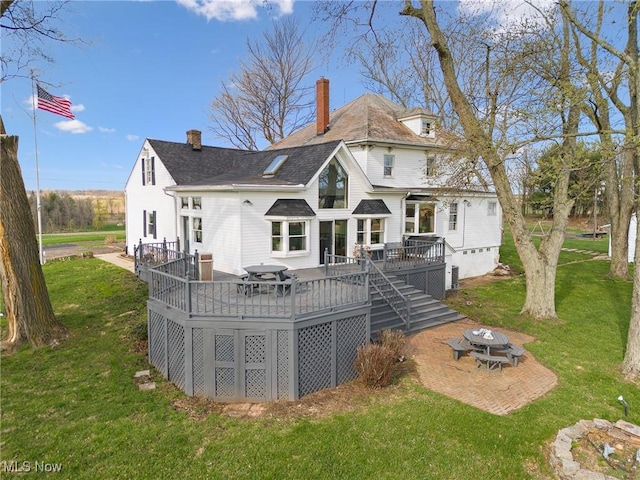 5706 Kemary Ave SW, Navarre, OH 44662 - back of property with a yard, a deck, and a chimney