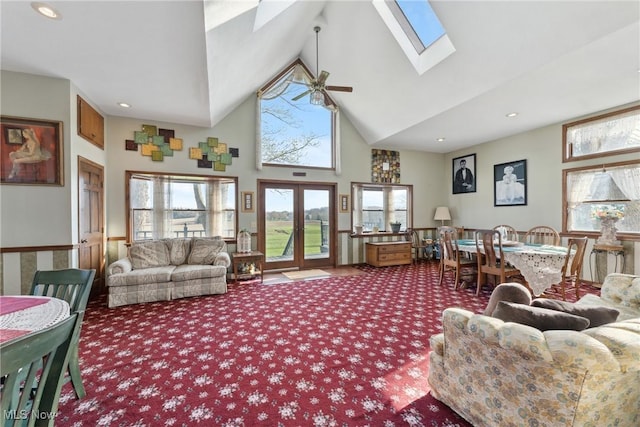 5706 Kemary Ave SW, Navarre, OH 44662 - living area featuring a ceiling fan, carpet, french doors, a skylight, and high vaulted ceiling
