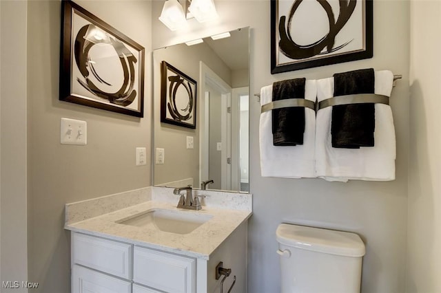 bathroom with toilet and vanity