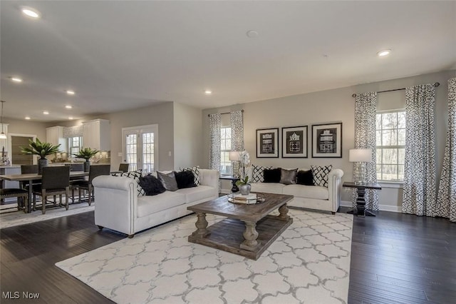 living room featuring dark wood-style flooring, baseboards, and recessed lighting