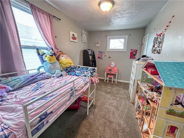 bedroom featuring a textured ceiling and carpet flooring