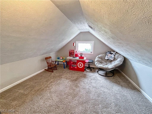 playroom with baseboards, a textured ceiling, and vaulted ceiling
