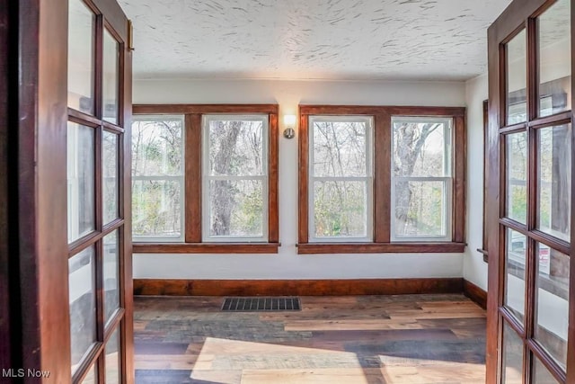 541 Canova Dr, Akron, OH 44319 - unfurnished sunroom with visible vents, baseboards, wood finished floors, and a healthy amount of sunlight