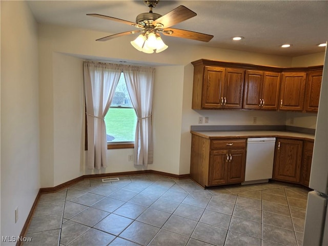 kitchen featuring light tile patterned floors, a ceiling fan, white appliances, and visible vents