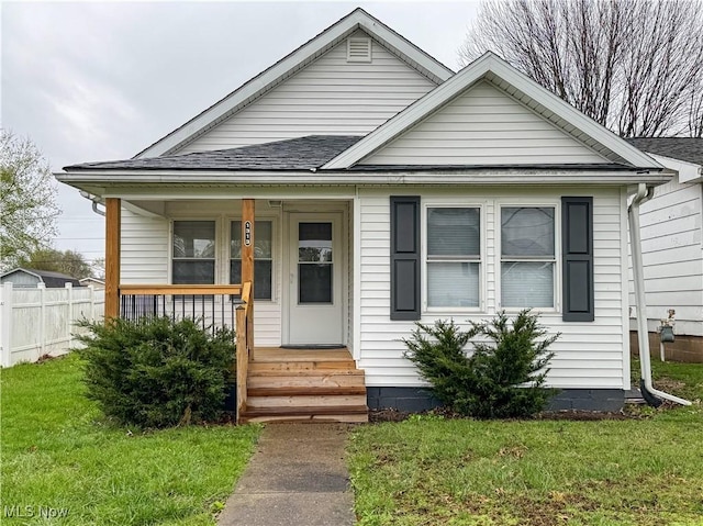 1313 12th St, Vienna, WV 26105 - bungalow-style home with a porch, a shingled roof, fence, and a front lawn