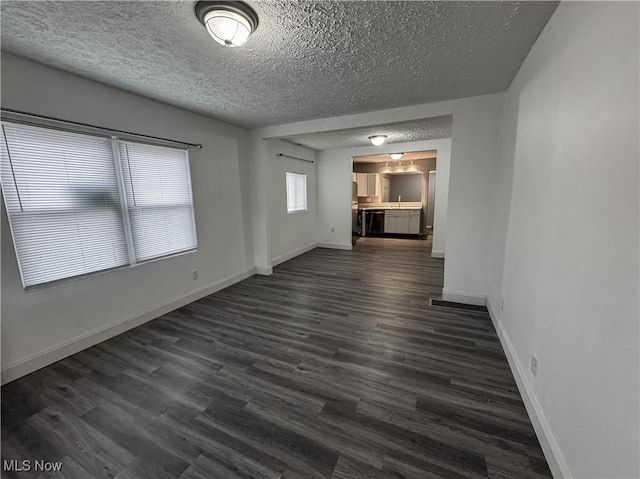 1313 12th St, Vienna, WV 26105 - empty room featuring dark wood finished floors, baseboards, and a textured ceiling