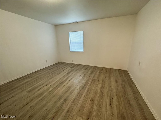 1313 12th St, Vienna, WV 26105 - empty room featuring wood finished floors and baseboards