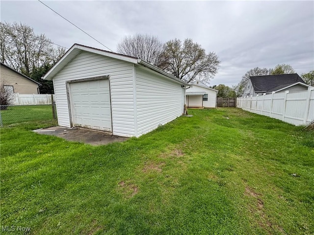 1313 12th St, Vienna, WV 26105 - detached garage featuring fence and driveway