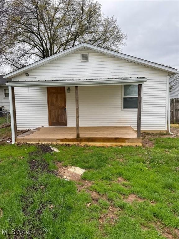 1313 12th St, Vienna, WV 26105 - rear view of house with a yard, a wooden deck, and fence