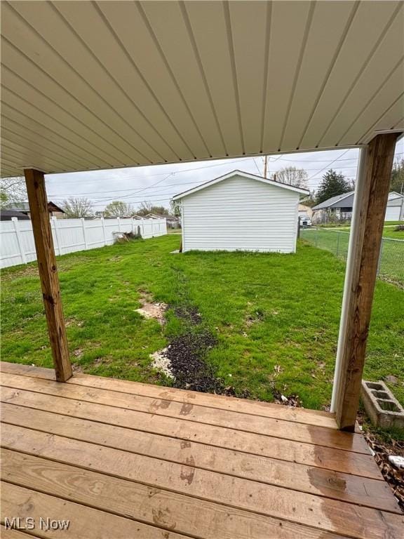 1313 12th St, Vienna, WV 26105 - wooden deck with an outdoor structure, fence, and a lawn