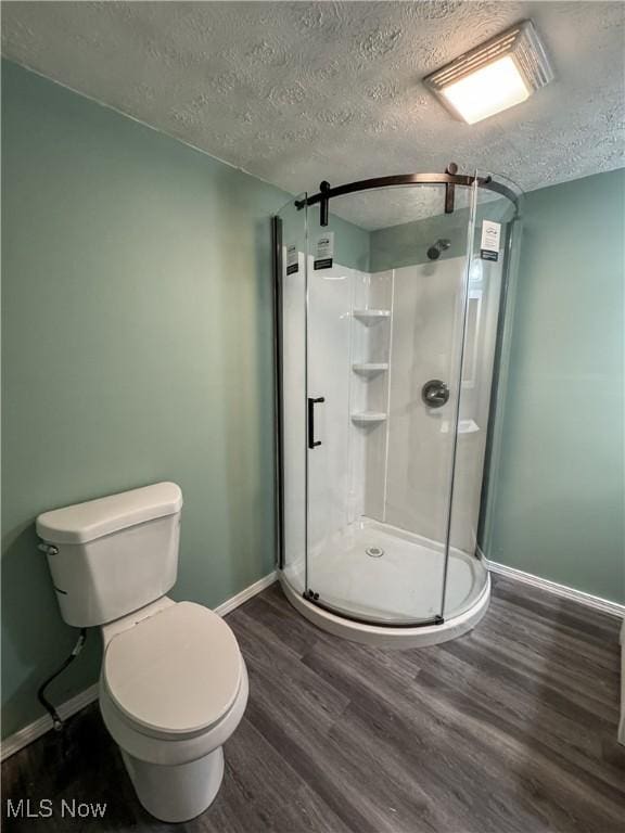 1313 12th St, Vienna, WV 26105 - full bathroom featuring a textured ceiling, baseboards, toilet, and wood finished floors