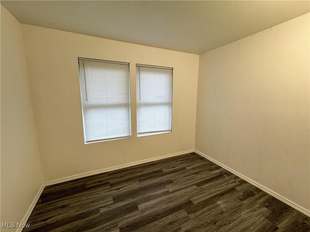 1313 12th St, Vienna, WV 26105 - spare room with dark wood-type flooring and baseboards