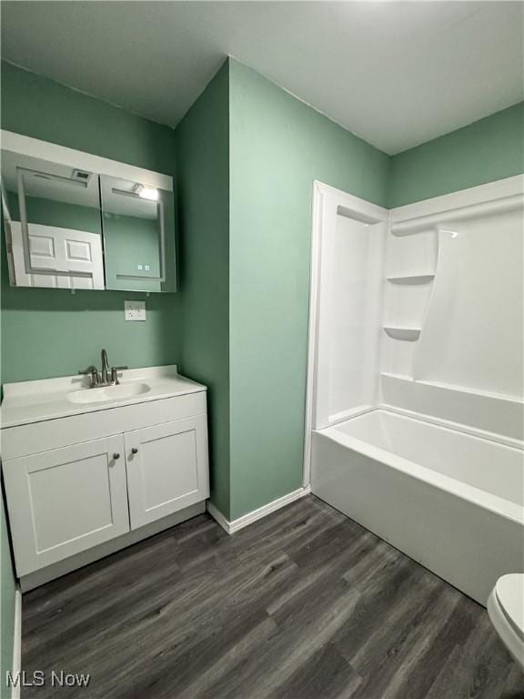 1313 12th St, Vienna, WV 26105 - full bathroom featuring shower / washtub combination, vanity, toilet, wood finished floors, and baseboards