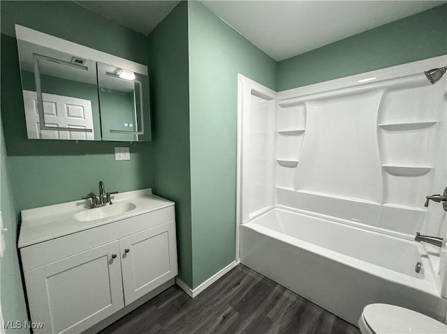 1313 12th St, Vienna, WV 26105 - full bathroom featuring bathing tub / shower combination, toilet, vanity, and wood finished floors