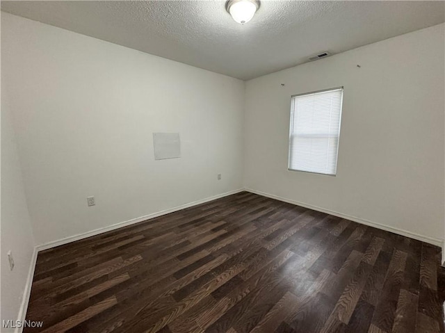1313 12th St, Vienna, WV 26105 - spare room with a textured ceiling, dark wood-style flooring, baseboards, and visible vents