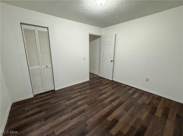 1313 12th St, Vienna, WV 26105 - unfurnished bedroom with dark wood-style flooring, a closet, and baseboards
