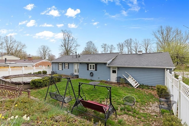 841 W Milton St, Alliance, OH 44601 - back of house featuring roof with shingles, a yard, a fenced backyard, and a chimney