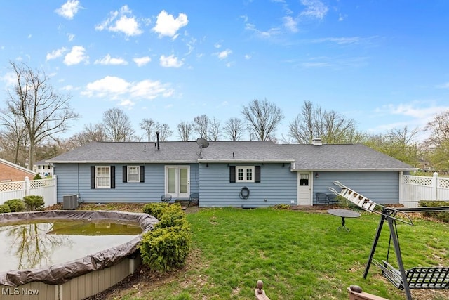 841 W Milton St, Alliance, OH 44601 - rear view of house with a chimney, a yard, fence, and central AC