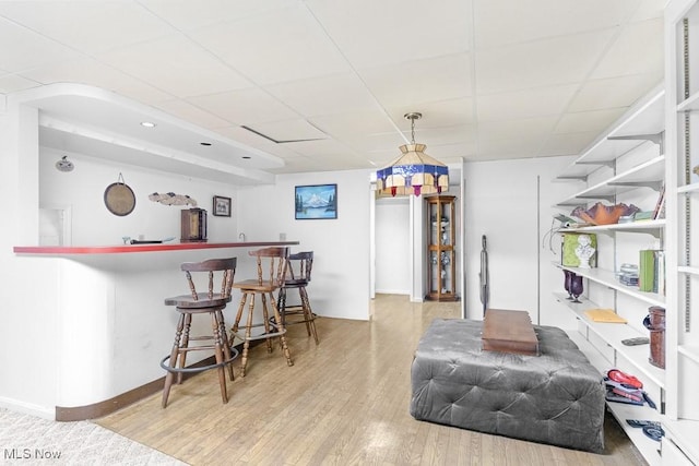 841 W Milton St, Alliance, OH 44601 - bar featuring a bar, baseboards, a drop ceiling, and wood finished floors