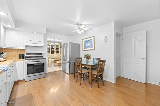 841 W Milton St, Alliance, OH 44601 - kitchen with light countertops, white cabinetry, under cabinet range hood, ceiling fan, and stainless steel appliances