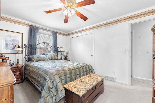 841 W Milton St, Alliance, OH 44601 - bedroom featuring a closet, baseboards, visible vents, a ceiling fan, and light colored carpet