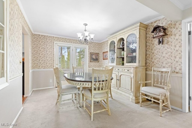 841 W Milton St, Alliance, OH 44601 - dining area featuring a notable chandelier, crown molding, wallpapered walls, a wainscoted wall, and light colored carpet