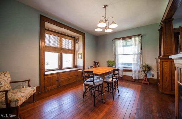 144 S Walnut St, Gnadenhutten, OH 44629 - dining space with dark wood-style flooring and a chandelier