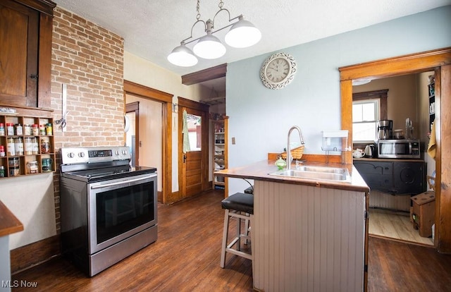144 S Walnut St, Gnadenhutten, OH 44629 - kitchen with a breakfast bar area, stainless steel appliances, dark wood-type flooring, and a sink