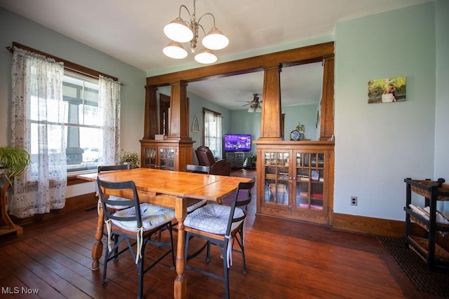 144 S Walnut St, Gnadenhutten, OH 44629 - dining room with baseboards, ceiling fan with notable chandelier, and dark wood-type flooring