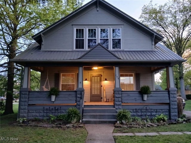 144 S Walnut St, Gnadenhutten, OH 44629 - view of front of house with a porch and metal roof