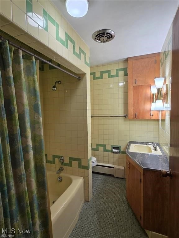 full bathroom with tile patterned flooring, visible vents, shower / bath combo, a baseboard heating unit, and tile walls