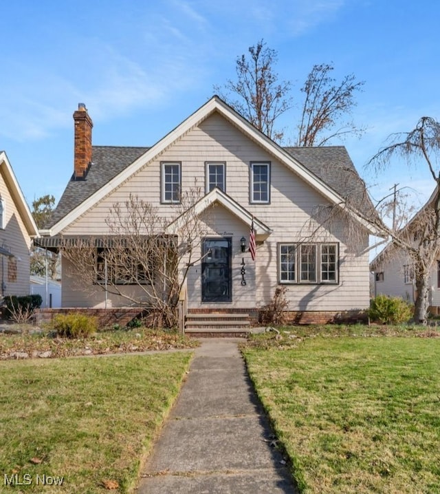 bungalow with a chimney and a front yard