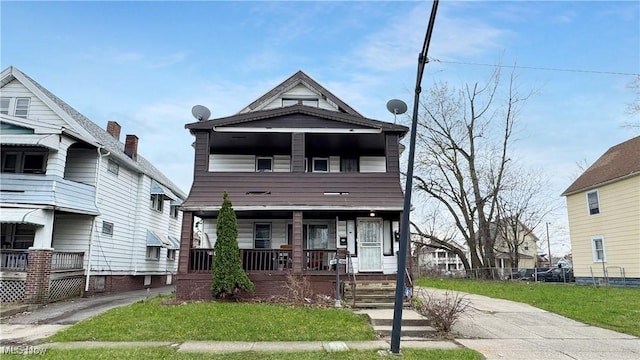 view of front of house with covered porch and a front yard
