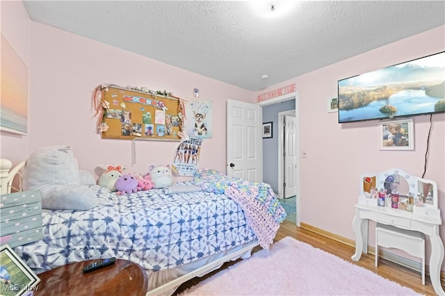4000 S Mahoning Ave, Alliance, OH 44601 - bedroom with a textured ceiling and wood finished floors