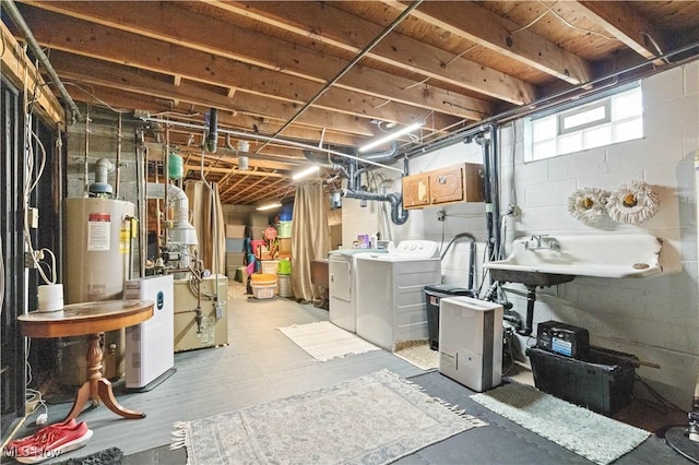 4000 S Mahoning Ave, Alliance, OH 44601 - below grade area featuring a sink, gas water heater, a heating unit, and washer and clothes dryer
