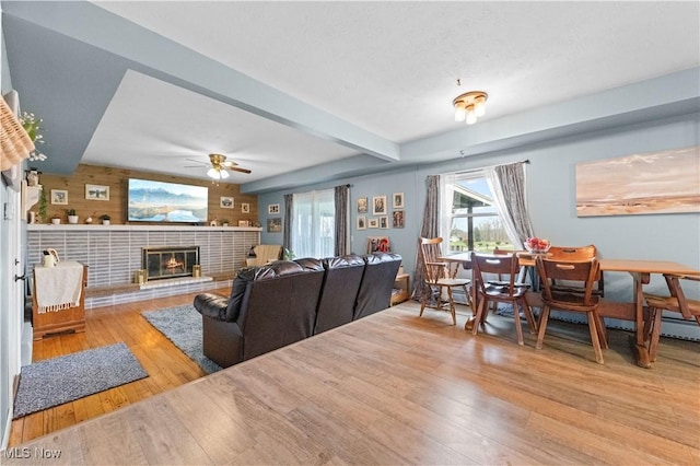 4000 S Mahoning Ave, Alliance, OH 44601 - living area with a glass covered fireplace, a ceiling fan, beam ceiling, and wood finished floors