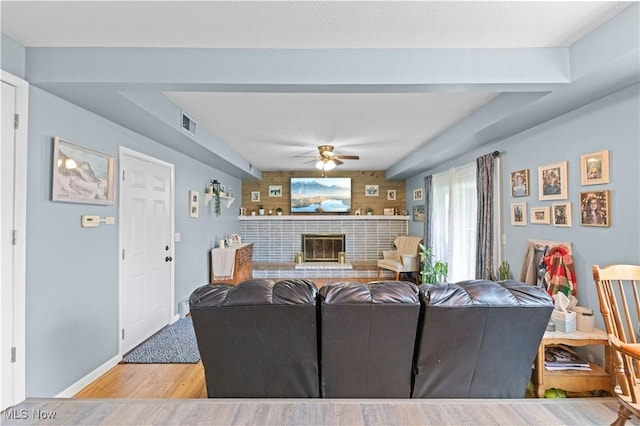 4000 S Mahoning Ave, Alliance, OH 44601 - living area with visible vents, a glass covered fireplace, baseboards, wood finished floors, and ceiling fan