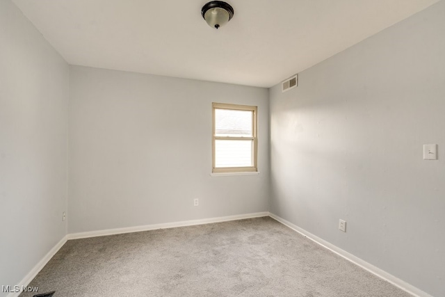 carpeted empty room with baseboards and visible vents