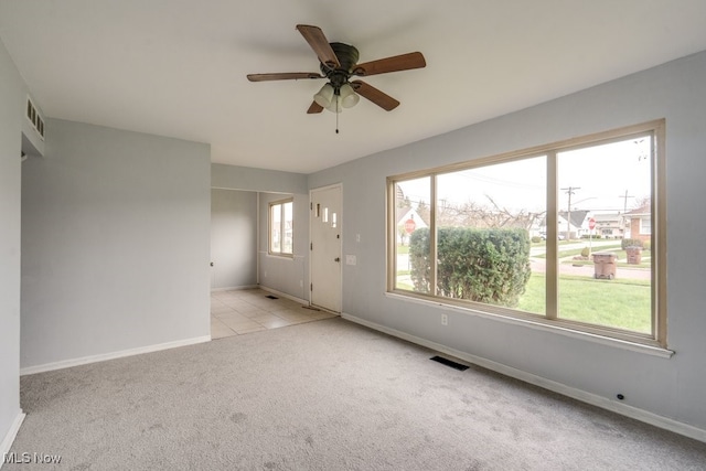 unfurnished room featuring visible vents, ceiling fan, carpet flooring, and baseboards