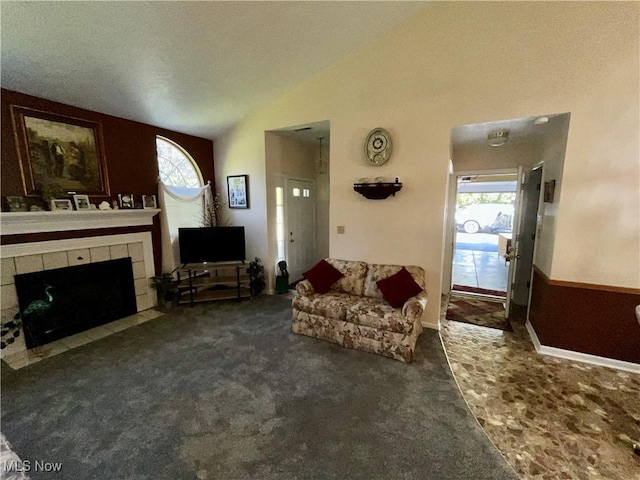 47 Woodland Chase Blvd, Niles, OH 44446 - living area featuring carpet flooring, a tiled fireplace, lofted ceiling, and a wealth of natural light