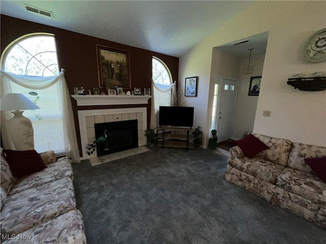 47 Woodland Chase Blvd, Niles, OH 44446 - living room with a tiled fireplace, carpet flooring, visible vents, and lofted ceiling