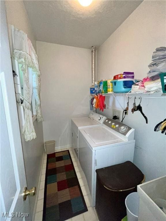 47 Woodland Chase Blvd, Niles, OH 44446 - washroom featuring laundry area, washing machine and clothes dryer, light tile patterned floors, and a textured ceiling
